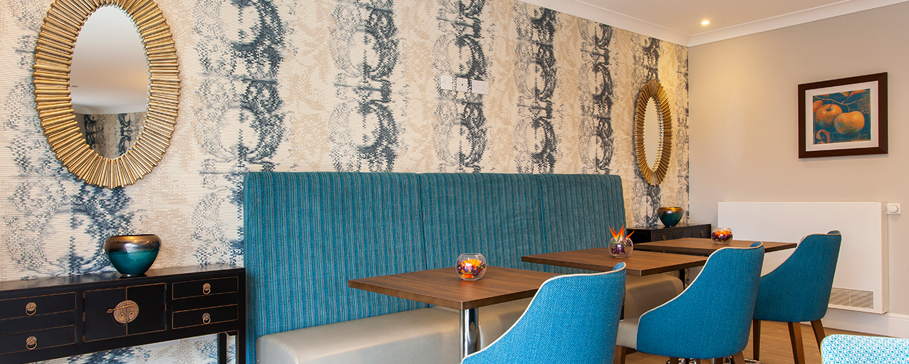 Blue and gold themed dining room at Penrose Court Care Home
