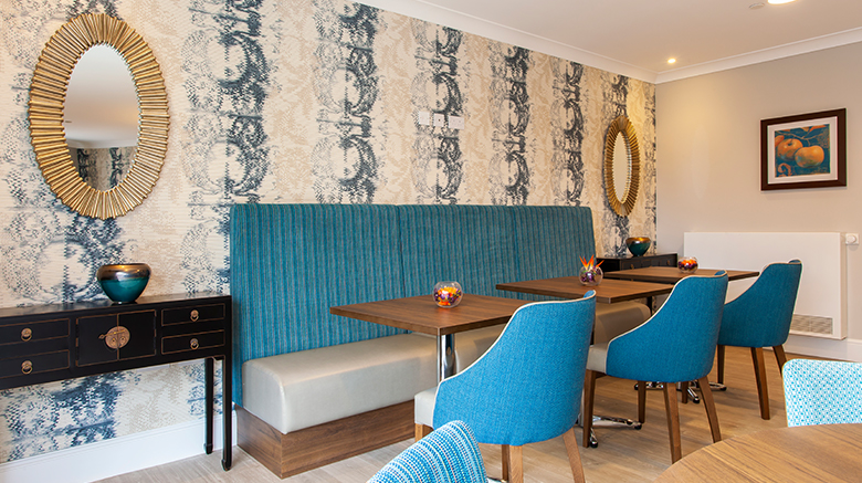 Blue and gold themed dining room at Penrose Court Care Home