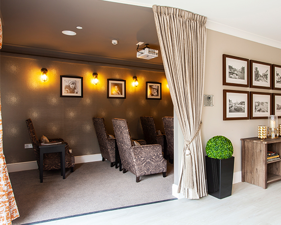 Comfy seats in the cinema room behind pulled back drapes at Penrose Court Care Home