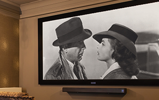 A close up of a black and white movie on the projector in the cinema room at Penrose Court Care Home