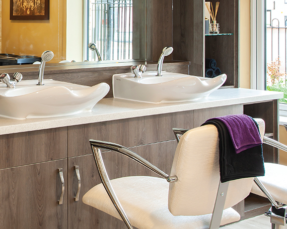 A close up of a comfortable seat and the sink stations in the Hairdressers & Beauty Salon at Penrose Court Care Home