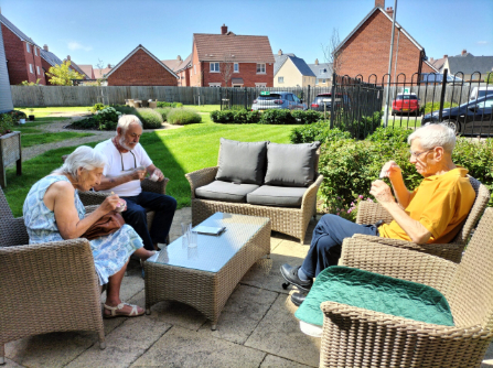 residents sat outside in the sun together