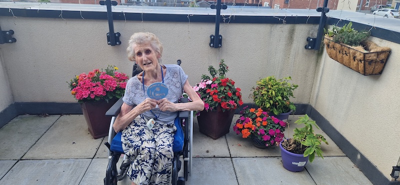 one of our residents sat with her flowers