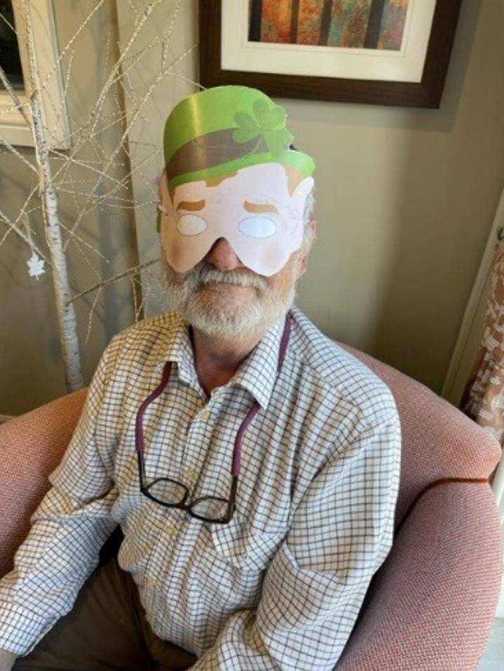 resident wearing a St Patricks Day mask