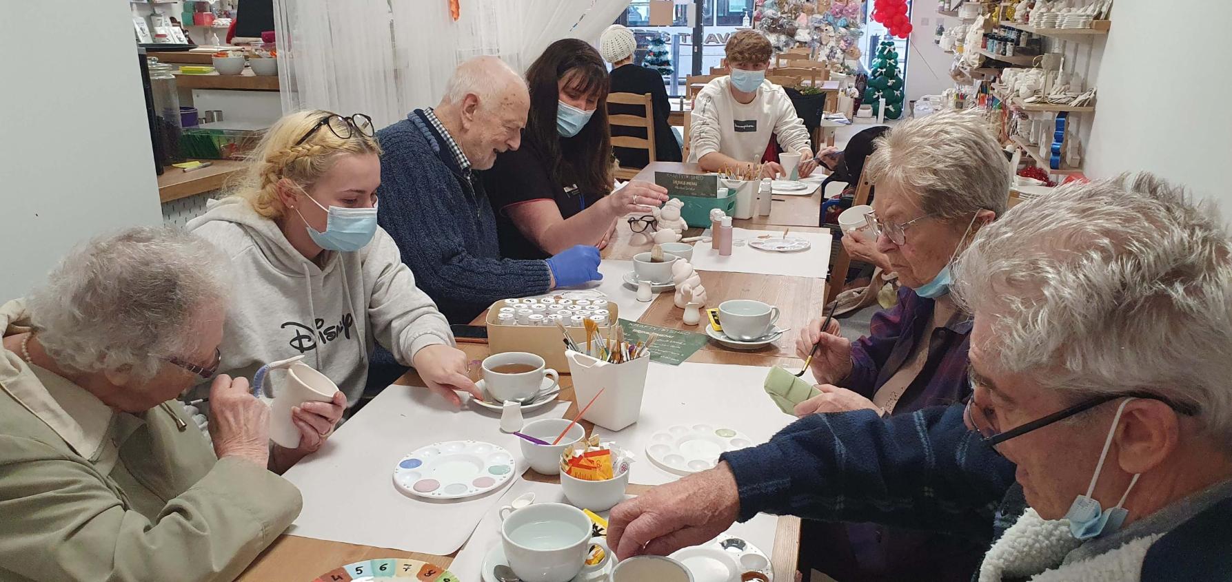 some of our residents doing pottery painting together