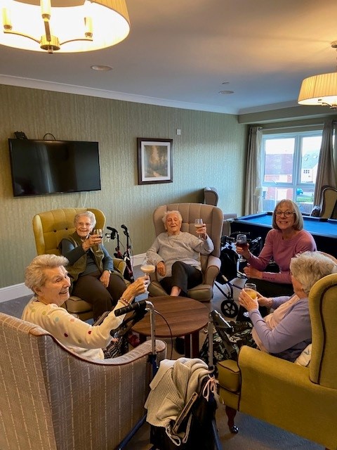 residents enjoying drinks with their friends for their anniversay